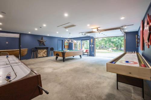 a living room with two billiard tables and a pool table at Muskoka Hutt in Huntsville