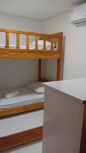 two bunk beds in a small room with a counter at Pôr do sol beach house in Porto Seguro