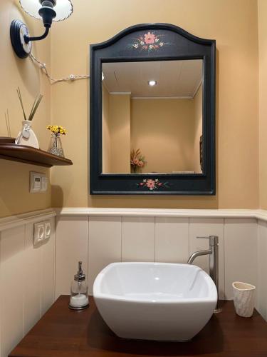 a bathroom with a white sink and a mirror at La Casa Del Pla in Pla de l'Ermita