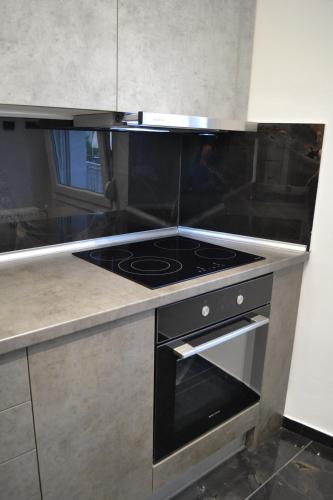 a kitchen with a black stove top oven at kaleos in Nea Chili