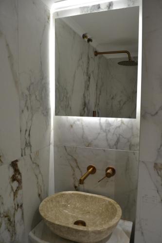 a bathroom with a stone sink and a mirror at kaleos in Nea Chili
