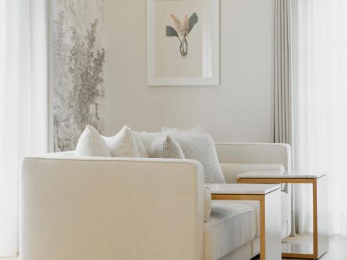 a living room with a white couch and a chair at Hotel Maria Camille in San Miguel de Allende