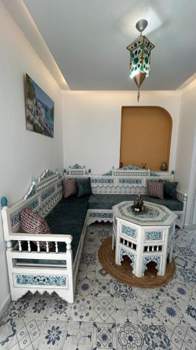 a living room with a couch and a table at Dar Omi Aïcha 2 in Kerkouene