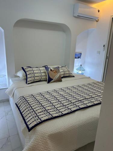 a bedroom with a bed with a keyboard on it at Dar Omi Aïcha 2 in Kerkouene
