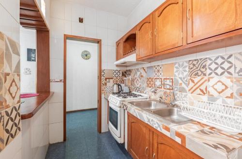 a kitchen with a sink and a stove top oven at casa de los espejos Av Cuauhtémoc in Mexico City