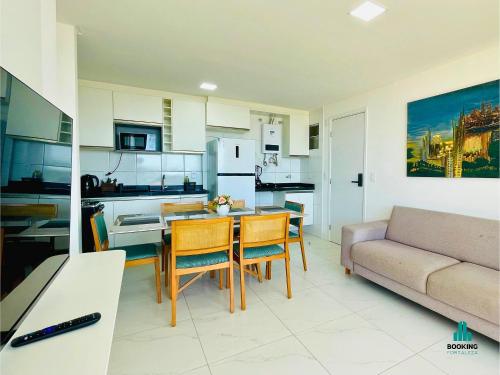 a kitchen and living room with a table and chairs at Aquarius Style by Holiday Stays in Fortaleza