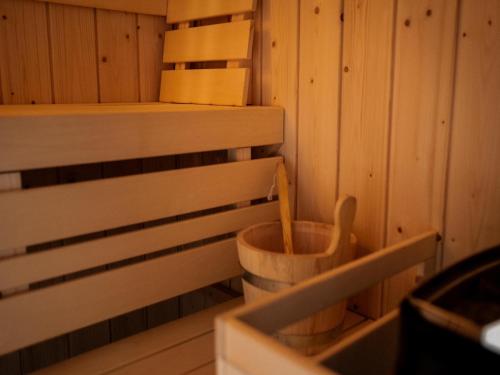 a sauna with a wooden toilet in the corner at Holiday Home in Haarle near Sallandse Heuvelrug in Haarle