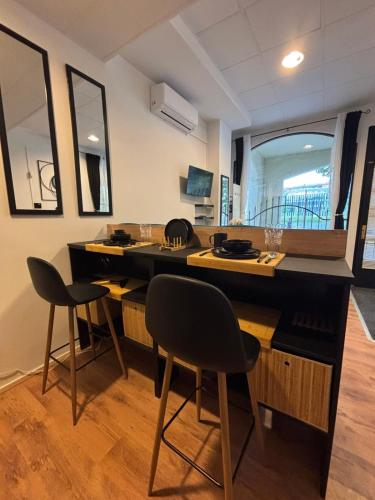 a kitchen with two chairs and a counter top at Studio Lent Riverstay in Maribor