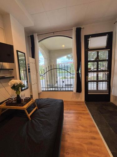 a living room with a bed and a large window at Studio Lent Riverstay in Maribor