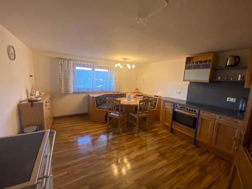 a kitchen with a table and a dining room at Haus Ernestine in Sankt Urban