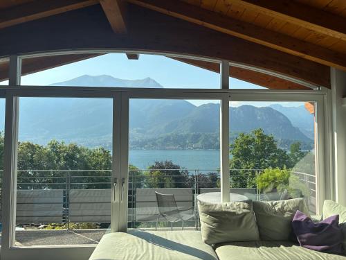 a living room with a large window with a view at Antica Residenza I Ronchi Di Bellagio in Bellagio