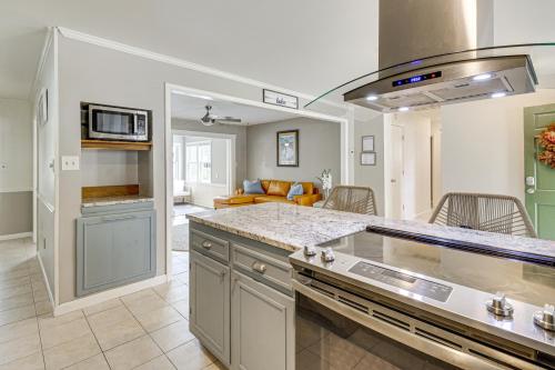 a kitchen with a counter top and a living room at Riverfront Fun Quiet Home Near Hampton Coastline in Hampton