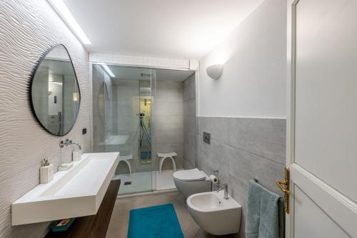 a bathroom with a sink and a toilet and a mirror at Portofino Riviera Luxury Villa-Pool,Garden,Parking in Zoagli