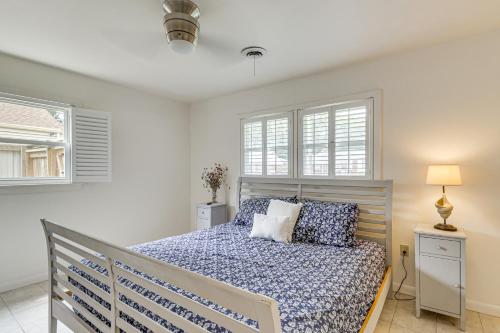 a bedroom with a bed and two windows at Riverfront Fun Quiet Home Near Hampton Coastline in Hampton