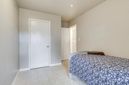 a bedroom with a bed and a white door at Riverfront Fun Quiet Home Near Hampton Coastline in Hampton