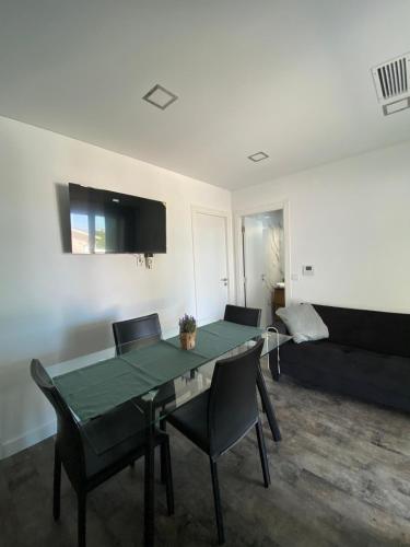 a living room with a table and chairs and a couch at Alex Guest House in Quinta do Anjo