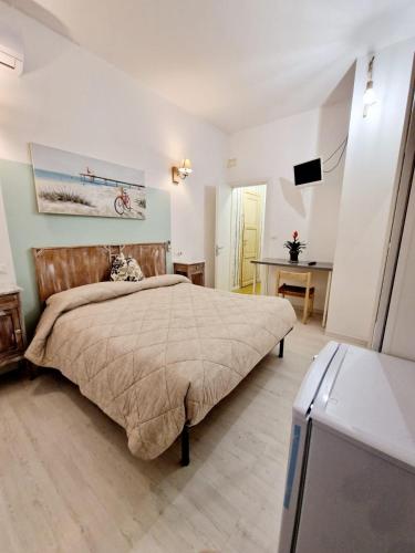 a bedroom with a bed and a flat screen tv at Ca' MaEle in Cattolica