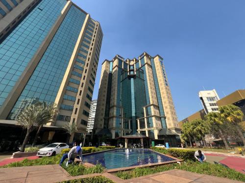 a group of buildings with a pool in front of it at Hotel Wydn Ibirapuera Moema in Sao Paulo