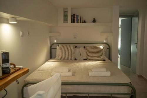a small bedroom with a bed with towels on it at Naousa's Melody in Naousa