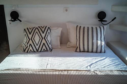 a bed with two pillows on top of it at Naousa's Melody in Naousa