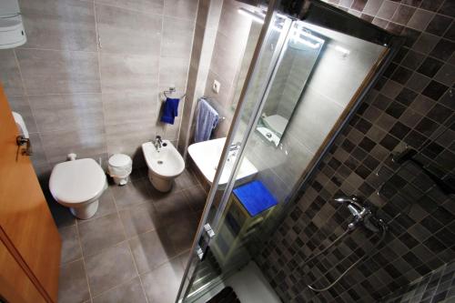 a bathroom with a toilet and a sink and a mirror at La Brisa - ocean view holiday apartment in Calpe in Calpe