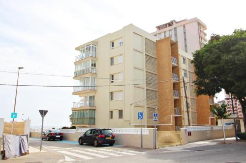 a car is parked in front of a building at La Brisa - ocean view holiday apartment in Calpe in Calpe