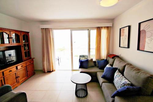 a living room with a couch and a table at La Brisa - ocean view holiday apartment in Calpe in Calpe