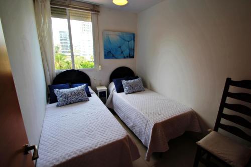 a room with two beds and a window at La Brisa - ocean view holiday apartment in Calpe in Calpe