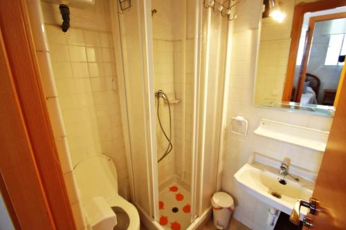 a bathroom with a shower and a toilet and a sink at La Brisa - ocean view holiday apartment in Calpe in Calpe