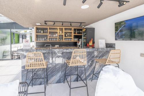 a bar with three chairs and a counter at Mad İnn Lara in Antalya
