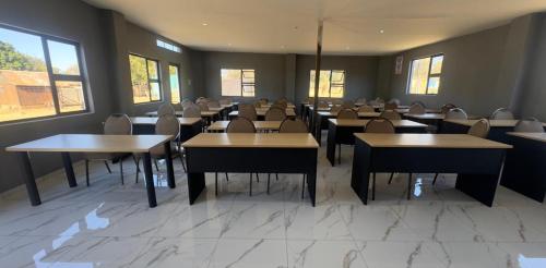 a dining room with tables and chairs and windows at GMC-facilities in Centurion