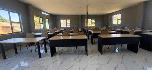 a dining room with tables and chairs and windows at GMC-facilities in Centurion