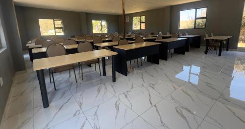 a restaurant with tables and chairs in a room at GMC-facilities in Centurion