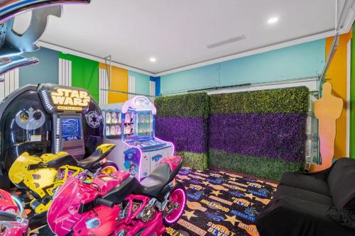 a room with two motorcycles parked next to a star wars machine at 1021 Fantasy in Davenport
