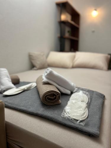 two towels and a tray on top of a bed at Apartman Stone Garden in Mostar