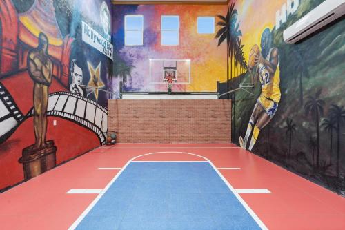 a room with a basketball court with paintings on the walls at 1021 Fantasy in Davenport