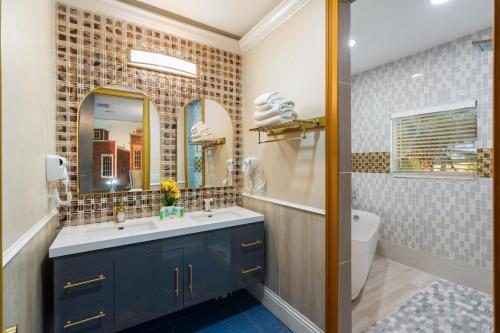 a bathroom with a sink and a mirror and a tub at 1021 Fantasy in Davenport