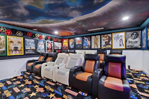 a movie room with chairs and posters on the wall at 1021 Fantasy in Davenport