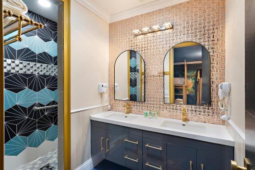 a bathroom with two sinks and two mirrors at 1021 Fantasy in Davenport