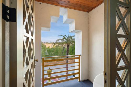 an open door to a balcony with a view of a palm tree at 1021 Fantasy in Davenport