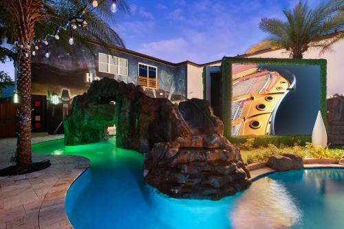 a pool with a water slide in front of a house at 1021 Fantasy in Davenport