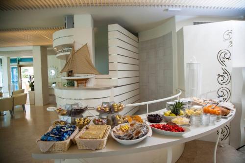 a table with many different types of food on it at Hotel Mon Cheri in Riccione