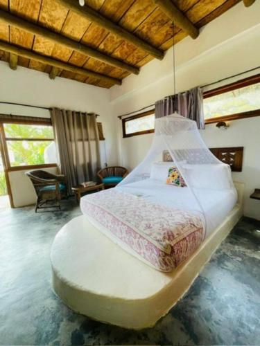 a bedroom with a large bed in a room at Casa Dibulla Hotel Boutique in Dibulla