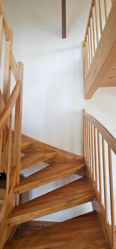 a wooden staircase in a room with wooden floors at Ferienwohnungen Das Finkhaus in Simonsberg