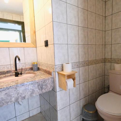 a bathroom with a toilet and a sink at Club Mel Holiday in Ortaca