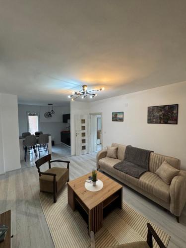 a living room with a couch and a table at Apartman Ćetković in Donji Milanovac