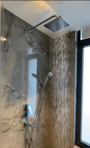 a shower in a bathroom with a shower curtain at Luxury at Solaris Appartment in Accra