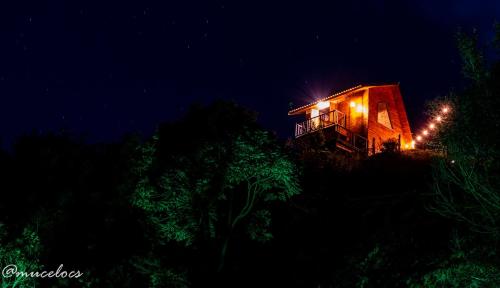 a house lit up at night with lights on it at TerraViva Glamping in Gonçalves