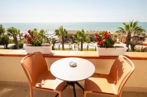 a table and chairs with a view of the ocean at Vila Lasko Hotel in Golem