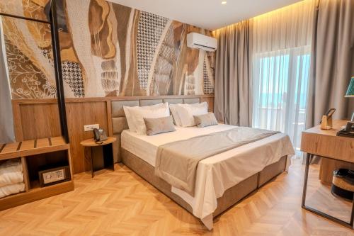 a bedroom with a large bed in a room at Vila Lasko Hotel in Golem